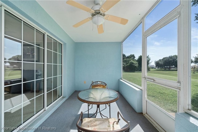 sunroom / solarium with ceiling fan