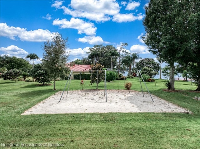 view of home's community featuring a lawn and a playground