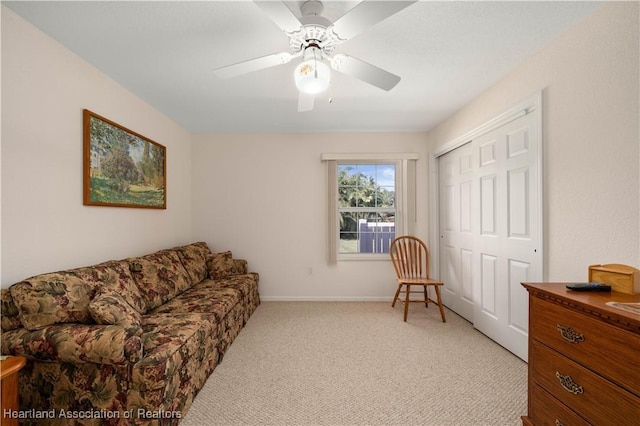 living area with ceiling fan and light colored carpet