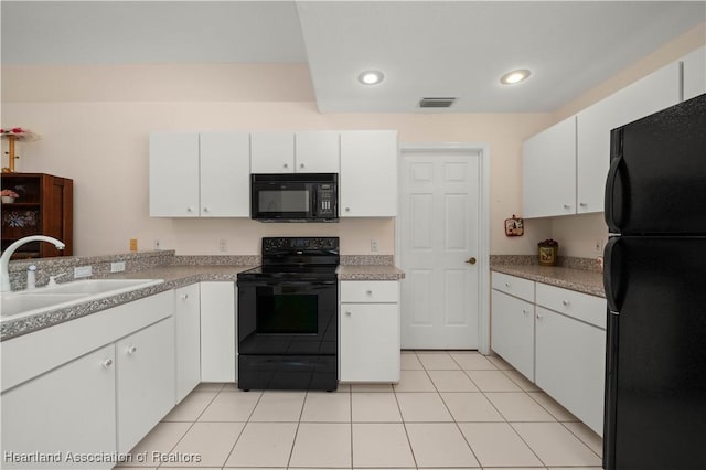 kitchen with white cabinetry, sink, light tile patterned floors, and black appliances