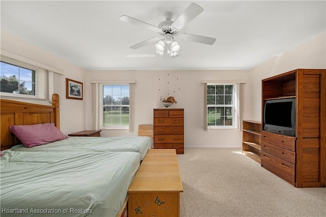 carpeted bedroom featuring ceiling fan