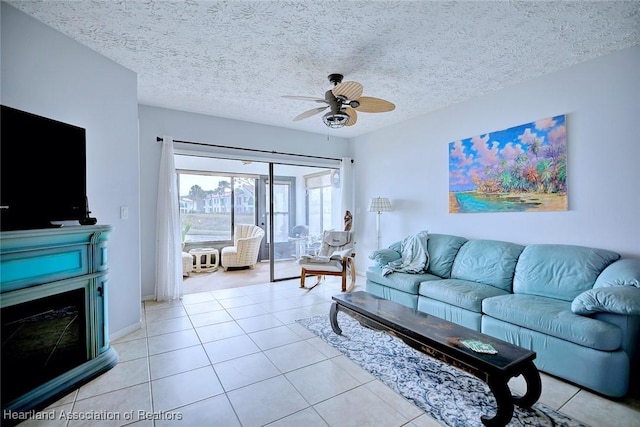 living room with light tile patterned floors, a textured ceiling, and ceiling fan