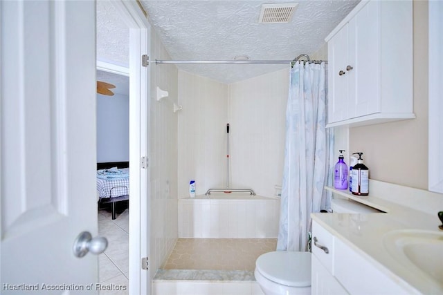 bathroom with toilet, vanity, a textured ceiling, and a shower with curtain