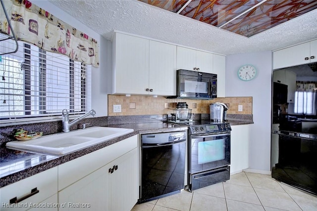 kitchen with white cabinetry, sink, black appliances, and a textured ceiling