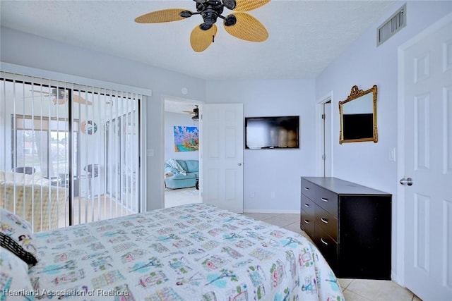 bedroom featuring ceiling fan, access to outside, a textured ceiling, and light tile patterned flooring