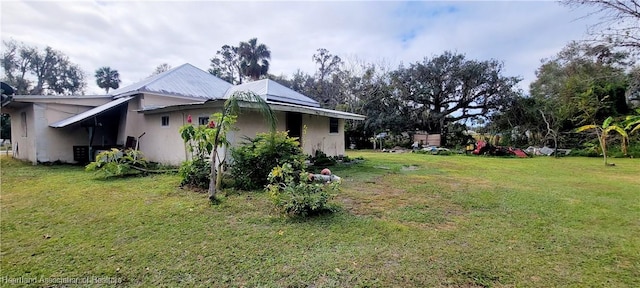 view of side of home featuring a lawn