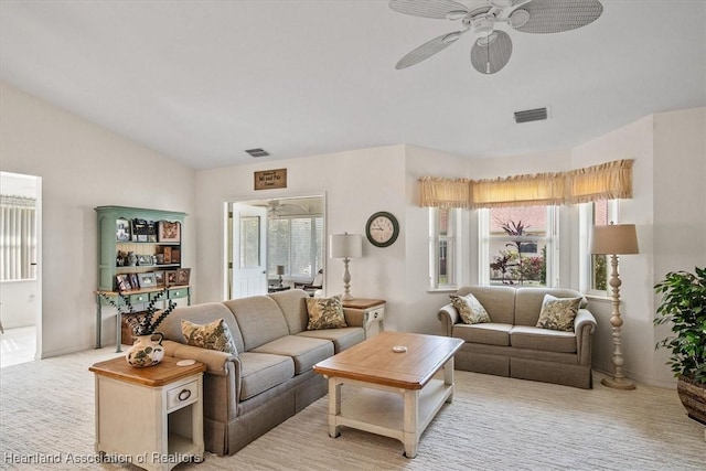 carpeted living room featuring vaulted ceiling, plenty of natural light, and ceiling fan