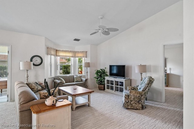 living room with vaulted ceiling, ceiling fan, and carpet flooring