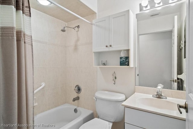 full bathroom with vanity, toilet, and shower / tub combo