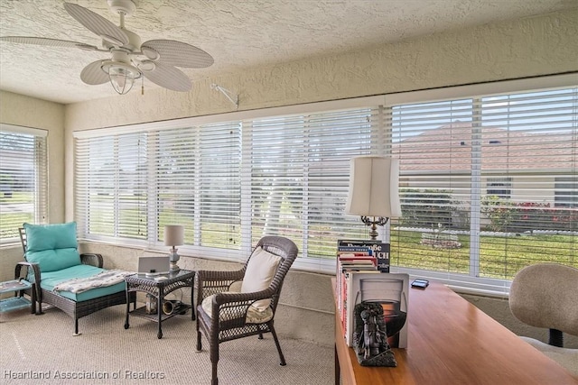 office space with ceiling fan, a healthy amount of sunlight, carpet, and a textured ceiling