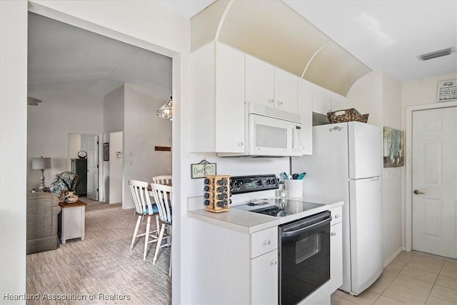 kitchen featuring lofted ceiling, light tile patterned floors, range with electric cooktop, and white cabinets