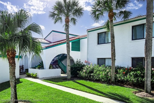 mediterranean / spanish-style home featuring a front lawn