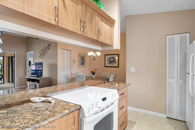 kitchen with light stone countertops, light brown cabinets, white refrigerator, stove, and a chandelier