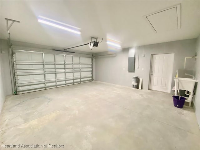 garage with electric panel and a sink