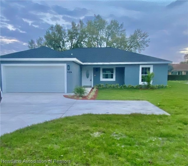 ranch-style house featuring a garage and a front yard