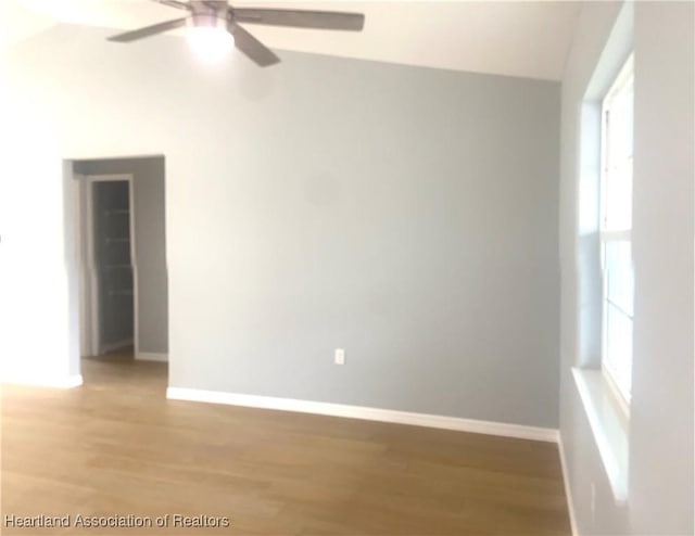 spare room with light wood-style flooring, baseboards, and ceiling fan