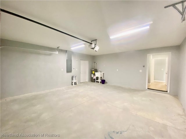 garage with electric panel, water heater, a garage door opener, and a sink