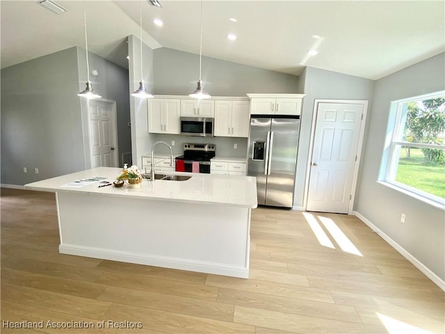 kitchen with visible vents, appliances with stainless steel finishes, light wood-style floors, white cabinets, and a sink