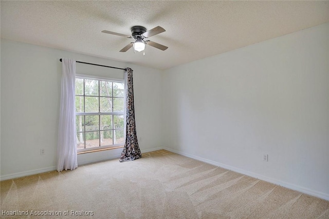 carpeted spare room with ceiling fan and a textured ceiling