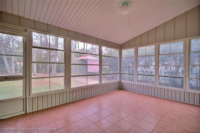 unfurnished sunroom featuring ceiling fan and vaulted ceiling