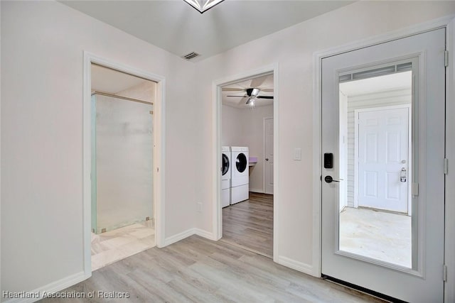 laundry room with light hardwood / wood-style flooring, washer and clothes dryer, and ceiling fan