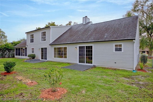 rear view of house with a lawn