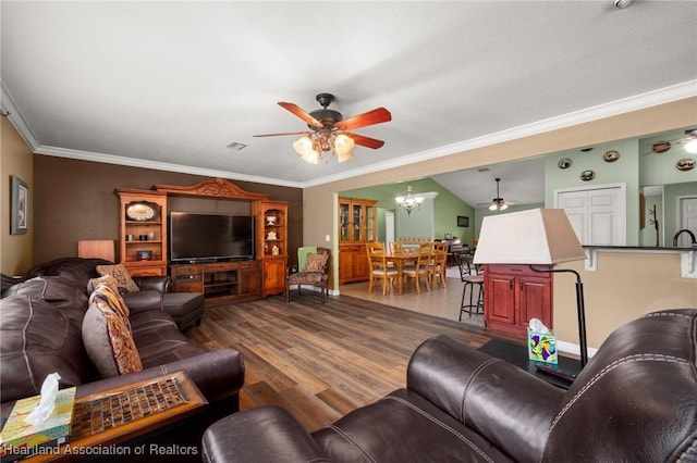4023 Santa Barbara Dr, Sebring, FL 33875 - living room featuring a ceiling fan, crown molding, dark wood-style flooring, and a chandelier