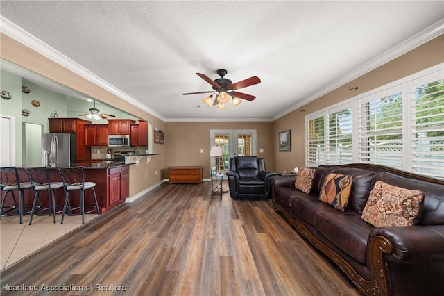 4023 Santa Barbara Dr, Sebring, FL 33875 - living room with a ceiling fan, dark wood-type flooring, crown molding, and baseboards