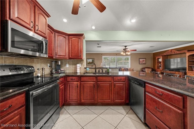4023 Santa Barbara Dr, Sebring, FL 33875 - kitchen featuring stainless steel appliances, ceiling fan, a sink, ornamental molding, and tasteful backsplash