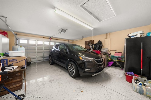 4023 Santa Barbara Dr, Sebring, FL 33875 - garage featuring a garage door opener and freestanding refrigerator