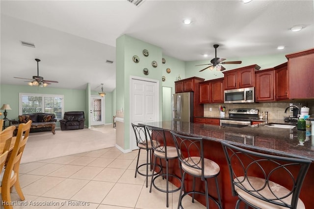 4023 Santa Barbara Dr, Sebring, FL 33875 - kitchen with stainless steel appliances, ceiling fan, a sink, light carpet, and recessed lighting