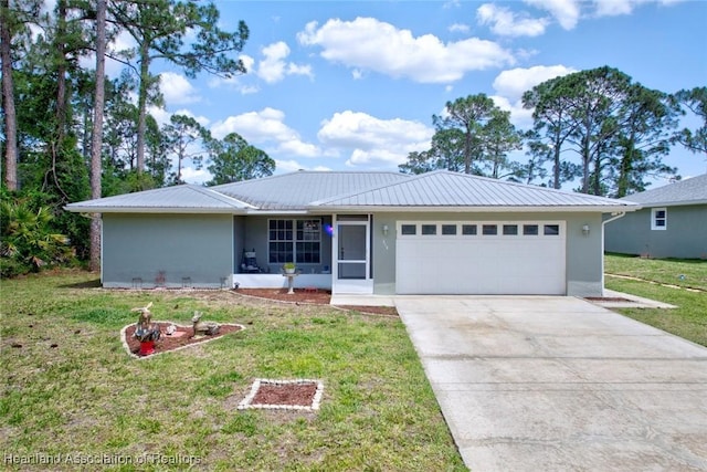 ranch-style house with an attached garage, driveway, a front lawn, and metal roof