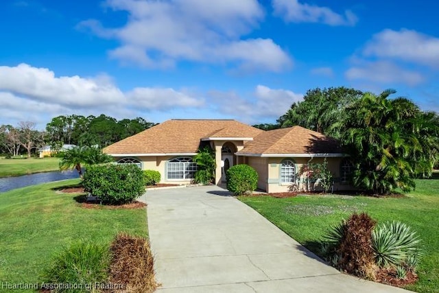 ranch-style home with a front lawn