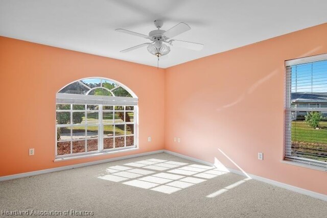 spare room with carpet flooring and ceiling fan