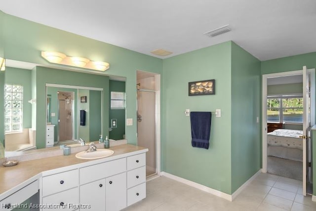 bathroom with vanity, tile patterned floors, and a shower with shower door