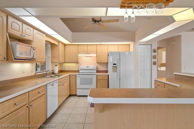 kitchen featuring light brown cabinetry, white appliances, and sink