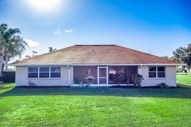 rear view of house with a lawn