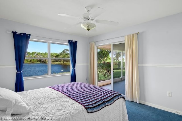 carpeted bedroom with access to exterior, a water view, and ceiling fan