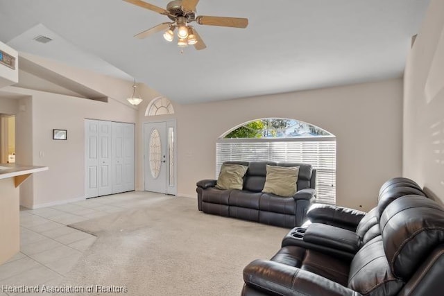 living room featuring light tile patterned floors, vaulted ceiling, and ceiling fan