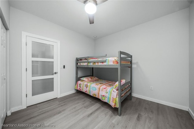 bedroom with ceiling fan, hardwood / wood-style floors, and a closet