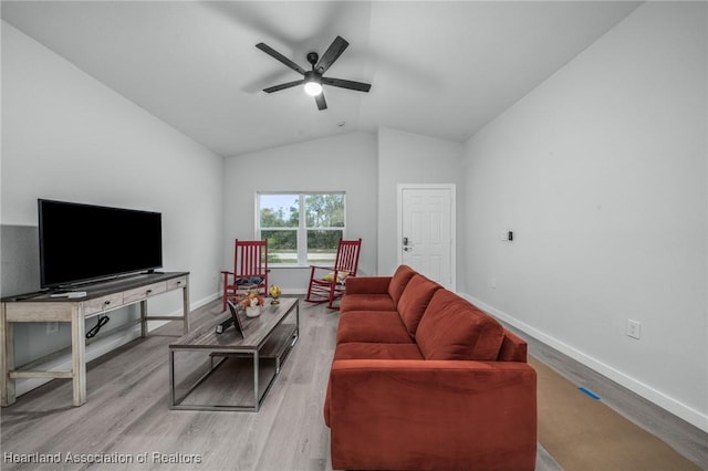 living room with ceiling fan, light hardwood / wood-style floors, and lofted ceiling