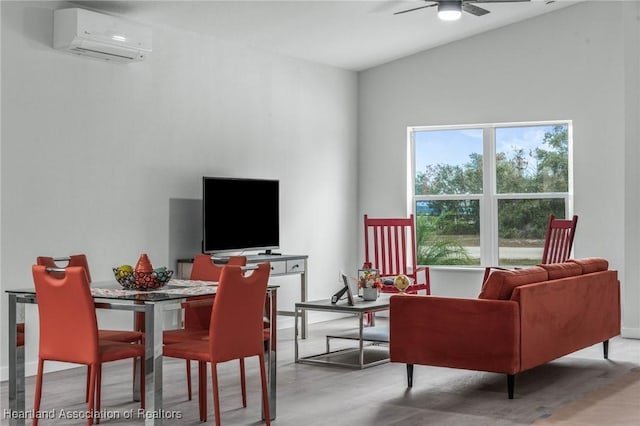 living room featuring ceiling fan and a wall mounted AC