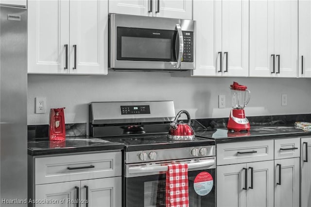 kitchen with white cabinets and appliances with stainless steel finishes