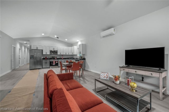 living room with a wall unit AC and vaulted ceiling