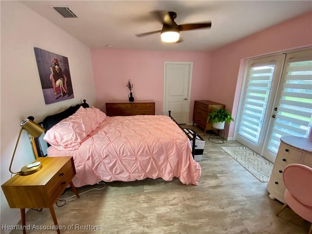 bedroom featuring access to outside, visible vents, ceiling fan, and light wood finished floors