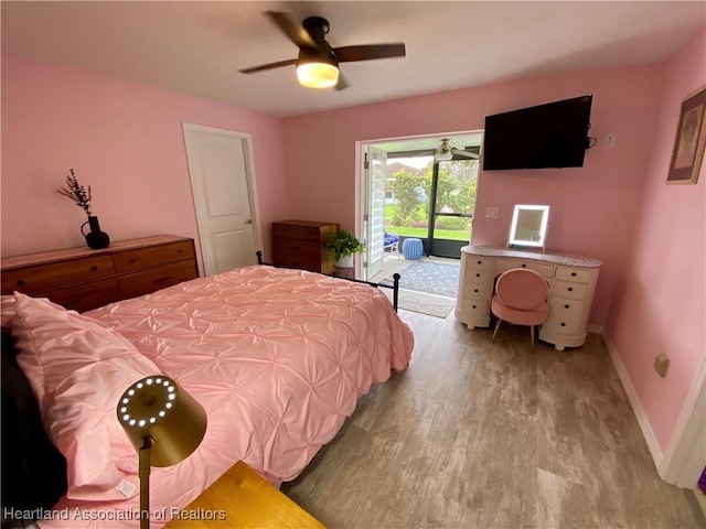 bedroom featuring access to outside, light wood-type flooring, a ceiling fan, and baseboards