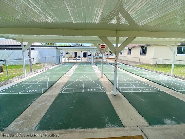 view of home's community featuring fence and shuffleboard