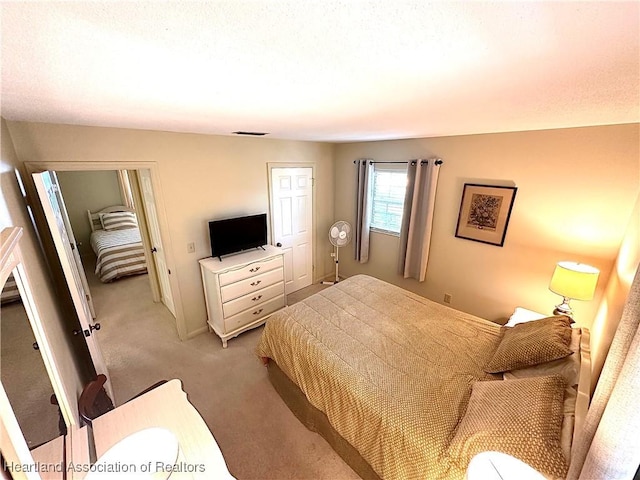bedroom with light colored carpet and visible vents