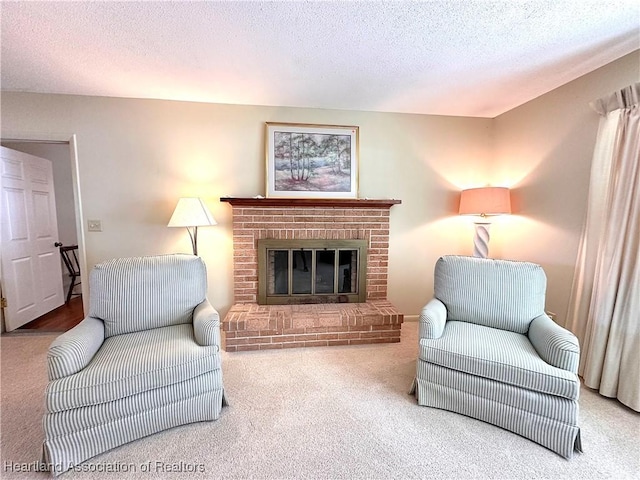 living room with a fireplace, carpet flooring, and a textured ceiling