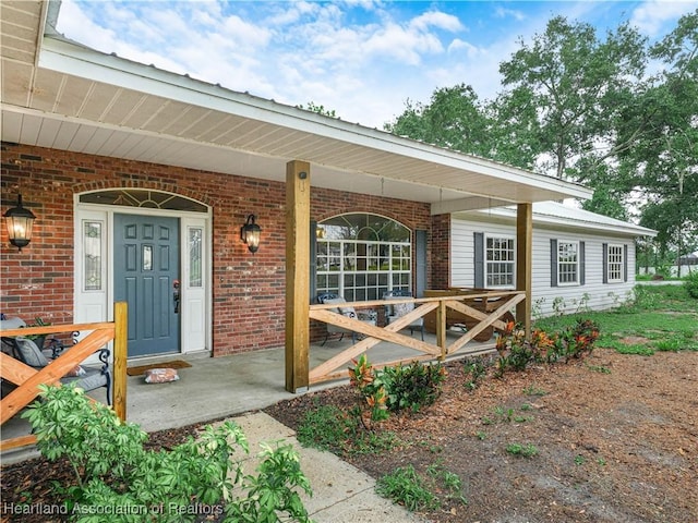 1494 Wilde St, Avon Park, FL 33825 - doorway to property with brick siding and covered porch
